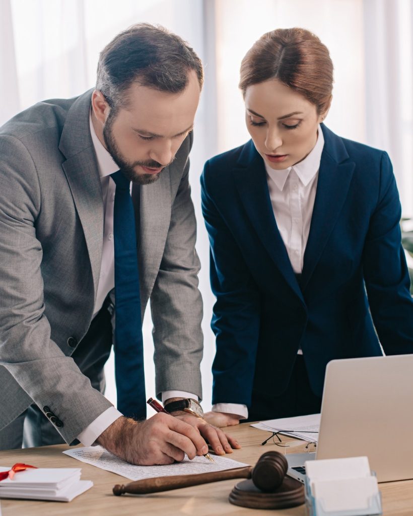 lawyers-in-suits-working-together-on-project-at-workplace-with-gavel-and-laptop-in-office.jpg lawyers-in-suits-working-together-on-project-at-workplace-with-gavel-and-laptop-in-office.jpg
